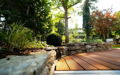A wooden deck surrounded by rocks and trees