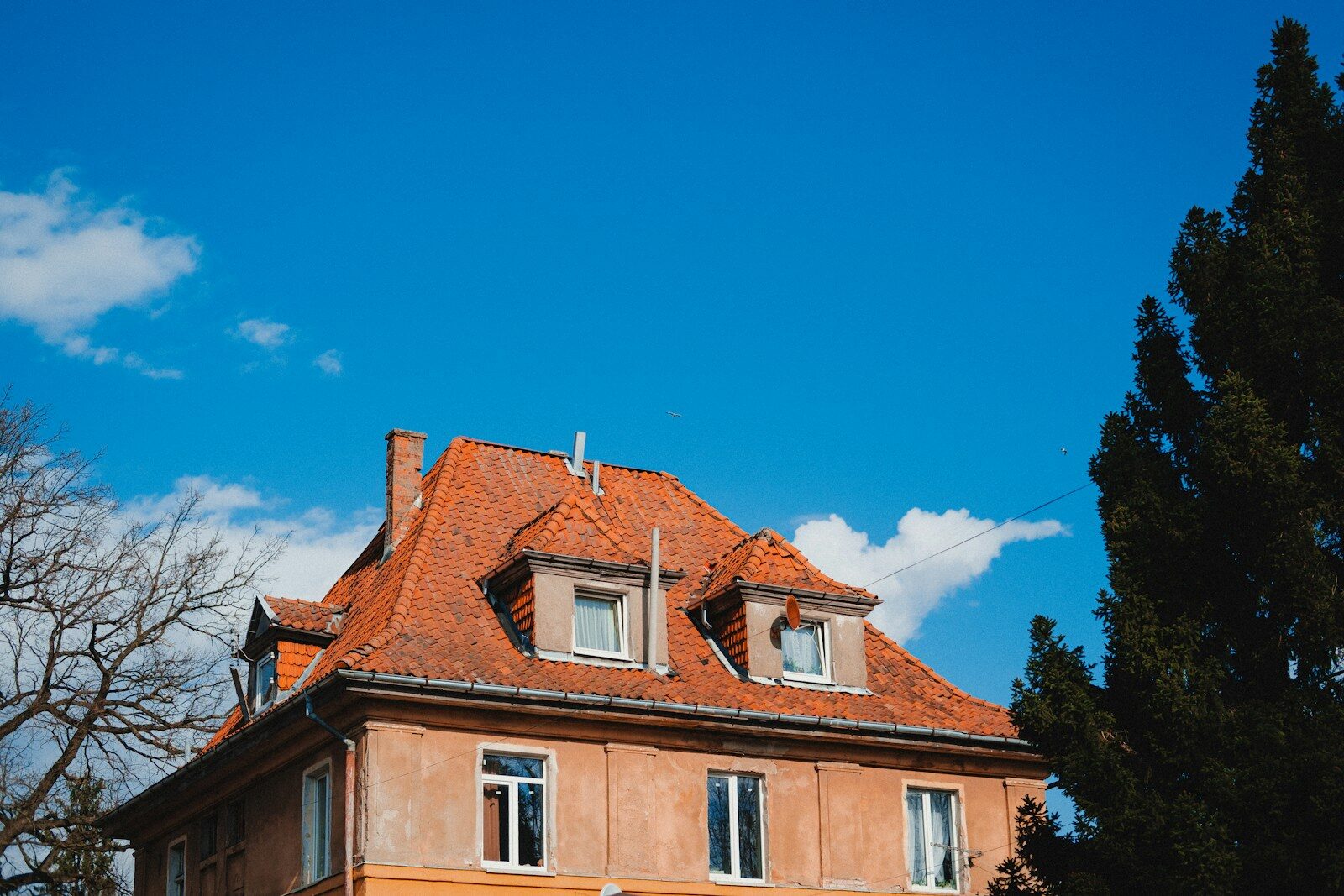Orange building with red roof under blue sky